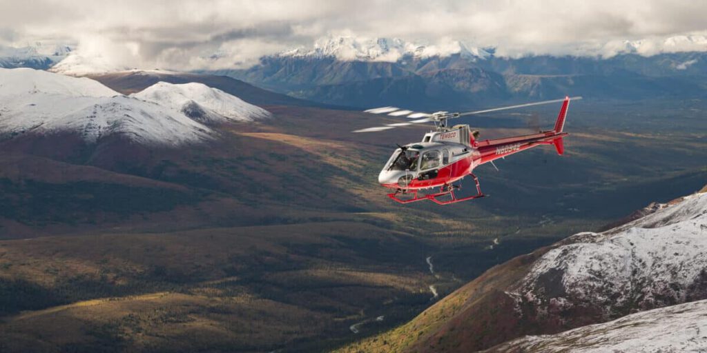 A helicopter charter flies above Denali National Park.