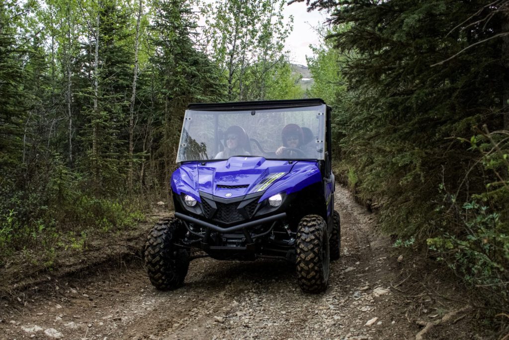 Riders enjoy a side-by-side ATV ride on the trail.