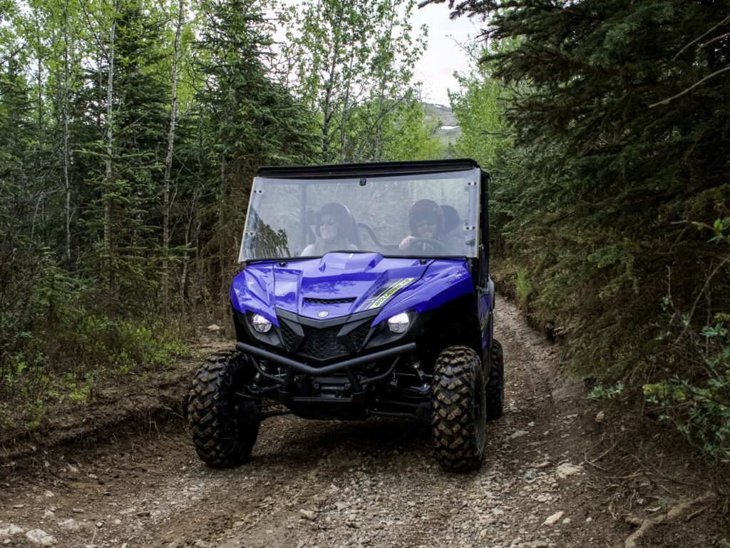 Riders enjoy a side-by-side ATV ride on the trail.