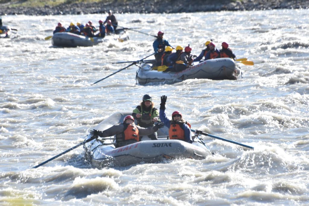 Several rafts paddle the Nenana River in Denali, Alaska.