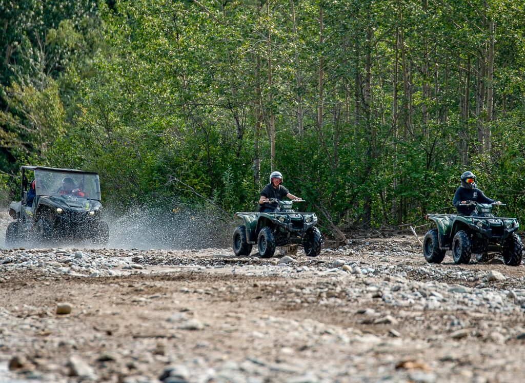 Two ATVs follow the lead guide on the trails in Denali