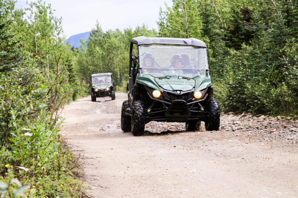 Two ATVs ride through the Alaskan backcountry.