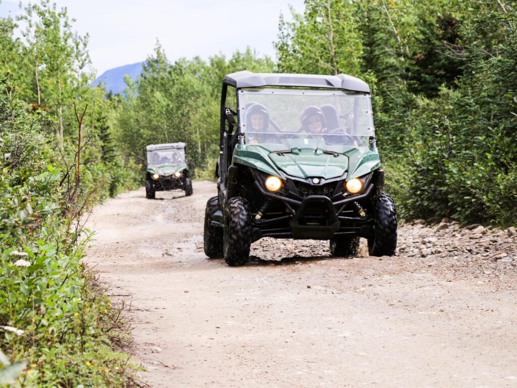 Two ATVs ride through the Alaskan backcountry.